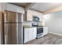 Bright kitchen featuring stainless steel appliances, white cabinets, and granite countertops at 1340 Bernard Nw St, Atlanta, GA 30314