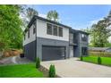 Beautiful two-story home featuring modern design, gray and white color scheme, and an attached garage at 921 Cone Rd, Forest Park, GA 30297