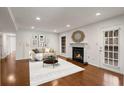 Bright living room features a fireplace, hardwood floors, and a decorative mirror above the mantel at 2116 N Forest Trl, Dunwoody, GA 30338