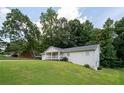 Quaint single-Gathering home with a charming front porch and a lush green lawn at 4567 Duncan Dr, Sugar Hill, GA 30518