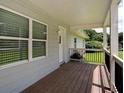 Inviting front porch with wood flooring and white railings, perfect for relaxing at 4567 Duncan Dr, Sugar Hill, GA 30518