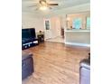 Spacious living room featuring hardwood floors with a view into the dining room at 4567 Duncan Dr, Sugar Hill, GA 30518