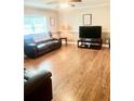 Spacious living room with hardwood floors and natural light from a large window at 4567 Duncan Dr, Sugar Hill, GA 30518