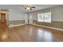 Bright living room with wood floors, neutral paint, and a large window at 4567 Duncan Dr, Sugar Hill, GA 30518