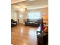 Inviting living room with hardwood floors and comfortable leather furniture at 4567 Duncan Dr, Sugar Hill, GA 30518