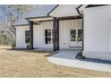 Attractive one-story home with white siding, black accents, a covered porch, and a well-manicured front lawn at 1270 Sandhill Hulett Rd, Villa Rica, GA 30180