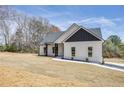Charming one-story home with white siding, black accents, a large front lawn, and a paved walkway to the front door at 1270 Sandhill Hulett Rd, Villa Rica, GA 30180