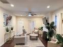 Bright living room with hardwood floors, a ceiling fan, a fireplace, and neutral-toned furniture at 24 Moreland Ne Ave, Atlanta, GA 30307