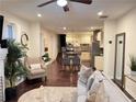 Open concept living area featuring hardwood floors, ceiling fan and a kitchen view at 24 Moreland Ne Ave, Atlanta, GA 30307