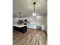 Open-concept kitchen featuring a large island, stainless steel appliances, and a built-in desk area at 602 Birch River Ln, Lawrenceville, GA 30043