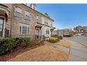 Exterior view of modern townhomes with well-kept landscaping and sidewalks at 2051 Glenview Park Cir, Duluth, GA 30097
