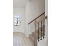 Inviting entryway features wood-look flooring and a staircase with modern wood handrails at 4179 Waratah Way, Mableton, GA 30126