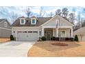 Inviting home with a manicured lawn, American flag, two-car garage, and welcoming entryway at 4901 Pleasantry Nw Way, Acworth, GA 30101