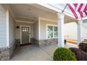 Inviting covered front porch with stone accents and a view of the home's entry at 4901 Pleasantry Nw Way, Acworth, GA 30101