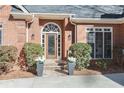 Inviting front entrance with a brick facade, decorative plants and stone steps at 4051 Ridgehurst Se Dr, Smyrna, GA 30080