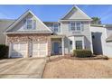 Charming home with stone accents, a two car garage, neat lawn, and blue shutters accenting the windows at 102 Crescent Woode Way, Dallas, GA 30157