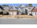 Inviting home with a two-car garage, stone accents, and well maintained lawn, perfect for Gathering living at 102 Crescent Woode Way, Dallas, GA 30157