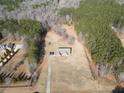 A beautiful aerial view of a charming home on a vast lot surrounded by luscious mature trees at 172 Lakeview Dr, Newborn, GA 30056