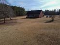 View of the home surrounded by vast yard, with lots of space and mature trees, offering privacy at 172 Lakeview Dr, Newborn, GA 30056