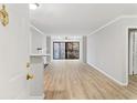 Bright living room with modern flooring, neutral walls, and sliding glass doors to a balcony, offering a peaceful view at 3110 Pine Heights Ne Dr, Atlanta, GA 30324