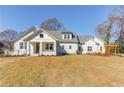 Charming single-story home with a well-maintained lawn, pergola and freshly painted white exterior at 505 Cochran Dr, Norcross, GA 30071