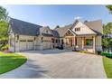 Inviting two-story home featuring a spacious driveway and a charming covered porch at 505 Cochran Dr, Norcross, GA 30071