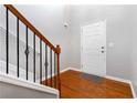 Inviting entryway with hardwood floors, staircase with a wooden railing and iron spindles, and a white front door at 239 Brookhaven Ct, Acworth, GA 30102