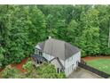 Aerial view of home, highlighting the back yard, deck and wooded, natural surroundings of the property at 6225 Leeward Tide Ct, Cumming, GA 30041