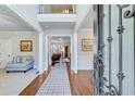 Grand foyer with high ceilings, hardwood floors, and decorative rug, leading into the open-concept living spaces at 6225 Leeward Tide Ct, Cumming, GA 30041