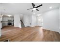 Open-concept living area with hardwood floors, a ceiling fan, and a staircase leading to the upper level at 780 Gardenside Se Cir, Marietta, GA 30067