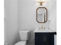 Elegant powder room with a navy vanity, white countertop, and stylish mirror at 780 Gardenside Se Cir, Marietta, GA 30067