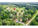 This home offers a serene setting with mature trees and a pond, all easily accessible via winding roads at 878 Forrester Cemetery Rd, Covington, GA 30014