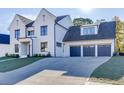 Stunning two-story home with a three-car garage and a spacious driveway, showcasing its architectural elegance at 2427 Wolf Meadow Ln, Buford, GA 30518