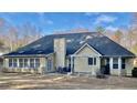 Back exterior showcasing a spacious backyard with patio, ideal for entertaining at 1959 Firelight Ln, Buford, GA 30519