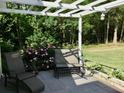 Relaxing outdoor patio with lounge chairs, pergola, and lush landscaping at 1959 Firelight Ln, Buford, GA 30519