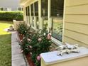 Exterior home details with blooming roses, manicured landscaping, and natural light at 1959 Firelight Ln, Buford, GA 30519