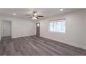 Bright living room featuring gray flooring, a ceiling fan, and a large window at 500 Pomona Sw Cir, Atlanta, GA 30315