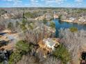 Stunning aerial view of the home nestled on a wooded lot with lake access, showcasing its serene setting at 210 Lawn Market, Sharpsburg, GA 30277