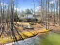 Expansive backyard with mature trees, a water feature, and a patio, ideal for outdoor entertaining at 210 Lawn Market, Sharpsburg, GA 30277