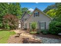 Beautiful home with a combination of stone and siding surrounded by mature trees at 210 Lawn Market, Sharpsburg, GA 30277