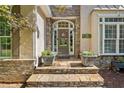 Close up of front entry with decorative wreath, stone details and potted plants at 210 Lawn Market, Sharpsburg, GA 30277