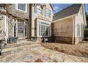Close-up of the front entrance featuring a stone facade, decorative door, and lush landscaping at 210 Lawn Market, Sharpsburg, GA 30277