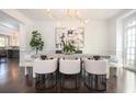 Elegant dining room with designer chandelier, hardwood floors, and white wainscoting with easy access to the kitchen at 3172 Ashford Dunwoody Ne Rd, Brookhaven, GA 30319