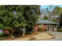 Cozy single-story home with a covered porch, mature landscaping, and a well-maintained yard at 42 W Belle Isle Ne Rd, Atlanta, GA 30342