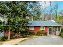 Charming single-story home with well-maintained landscaping and a screened-in porch at 42 W Belle Isle Ne Rd, Atlanta, GA 30342