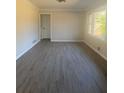 Bright living area with windows, neutral paint, and light vinyl plank flooring at 536 Joann Ave, Austell, GA 30168