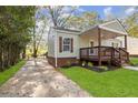 Charming home featuring a well-manicured lawn, driveway, and a porch at 2458 Calvin Ave, East Point, GA 30344