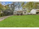 Charming home featuring a well-manicured lawn and inviting front porch at 2458 Calvin Ave, East Point, GA 30344