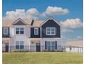Townhome showcasing a blue and white exterior, a black fence and a well-maintained lawn at 2765 Sandy Rd, Conyers, GA 30013