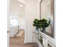 Hallway featuring a decorative mirror and console table leading to the kitchen at 2765 Sandy Rd, Conyers, GA 30013
